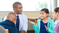 Teacher and students having a discussion in middle school