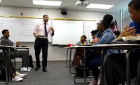 Teacher speaking in front of his class