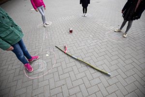 Schoolgirls stand in the corners of a square of chalk to observe the rules of distance on the playground of the Goldbeck School.