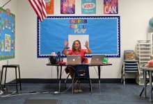 Elementary school teacher teaches virtually from her classroom