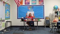 Elementary school teacher teaches virtually from her classroom
