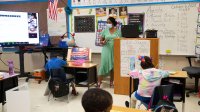 First grade teacher instructs a hybrid classroom
