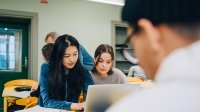 High school students work in small groups in classroom