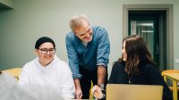 High school teacher works with students