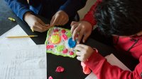 Two high school students use modeling clay in science class