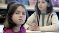 Students is paying close attention to a teacher in a classroom. 