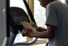 A student is doing an excercise while he is reading.