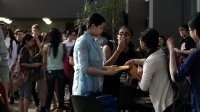 High School students are gathering infront of the school.