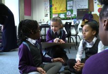 Primary students are talking in a group work together