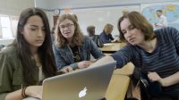 Girl students are working on a computer.