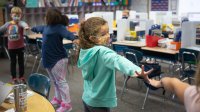 Students play a stretching game during a classroom break