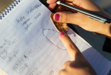 Student makes notes during outdoor science experiment