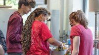 High school Latin students cook a meal