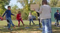 Third-grade students dance during an outdoor socially distanced music class. 