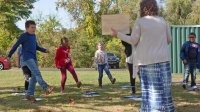 Third-grade students dance during an outdoor socially distanced music class.
