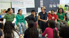 A diverse elementary ELL classroom sitting in a circle