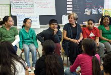 A diverse elementary ELL classroom sitting in a circle