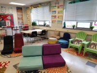 A flexible seating classroom with a variety of chairs, tables, rugs, and stools