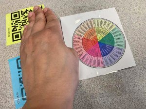 Hand selecting QR code for emotion tracker