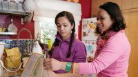 Mother and daughter cooking in their kitchen