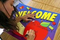 Elementary school teacher creating a welcome sign