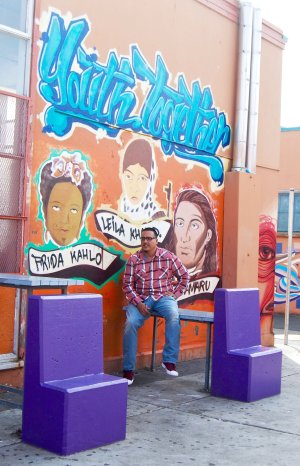 Francisco 'Franky' Navarro, restorative justice facilitator at Castlemont High School, sits in the campus courtyard.