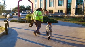 A father and his daughter walk outside of Educare.