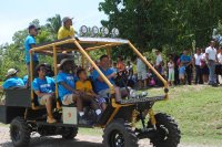 Teacher Brian Copes and his students riding together in a golf cart they modified