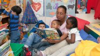 Preschool teacher reading to students 