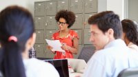 Woman speaking at teacher meeting