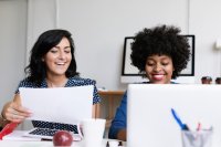 Two women collaborating with a laptop