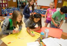 Middle students making posters in school