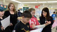 Two teachers work with students in math class