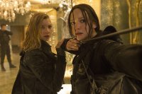 Hunger Games movie still showing the character Katniss Everdeen shooting an arrow