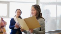 Middle school student doing a presentation in front of class.
