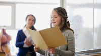 Middle school student doing a presentation in front of class. 