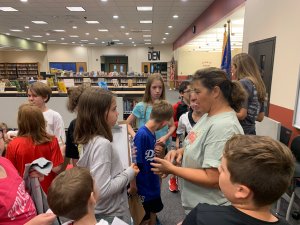 A farmer meets with students to talk about Climate Change.