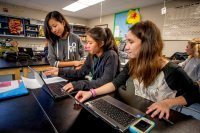 Students using laptops in science class