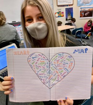 A student in Allison Berryhill's class holds up her heart map.