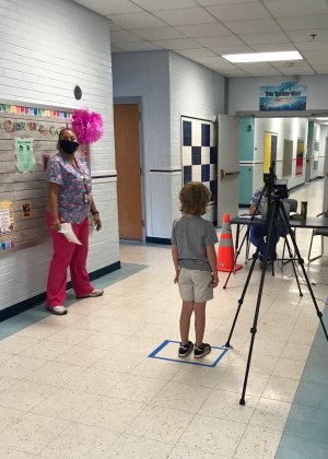 A student checks in at Meriden and goes through a health screening.