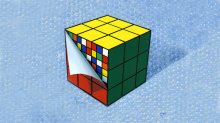 Illustration of a puzzle cube with peeling top layer