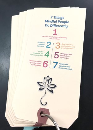 Deck of cards with mindfulness prompts on a silver ring.