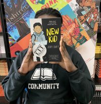 A student holds up a book from the school library