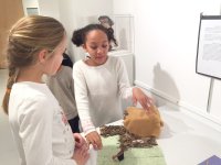 Two third grade girls from Friends School of Baltimore discuss a project about Native Americans.