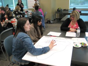 Two Renton High School students consult with a teacher on a project.