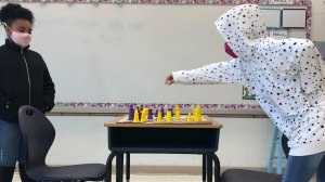 Students playing chess in class new crop