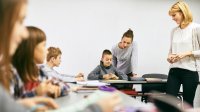 Elementary school classroom with two teachers and students