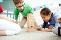 A group of elementary school students playing Jenga.