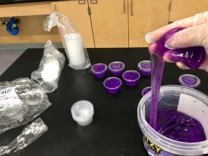 A Meriden staff member separates slime into condiment cups.