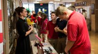 High school students reenacting various historical figures in a "wax museum" project